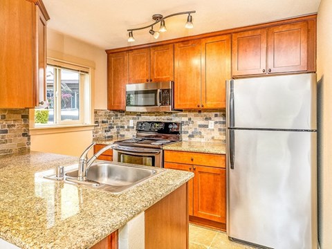 a kitchen with a sink and a refrigerator